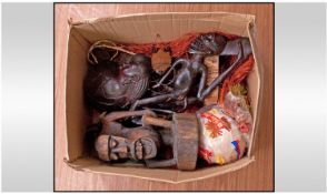 A Collection of African Artifacts comprising 6 native wood carvings, a grass skirt and an ostrich