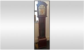 Reproduction Brass Arched Dial Face 8 Day Grandmother Clock. Glazed door front in a mahogany case