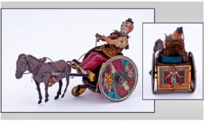 Lehman Antique And Rare Moving Parts Tin Toy. The clown driving his cart with a drunken donkey.
