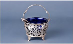 A Fine Silver Openwork Swing Handle Fruit Preserve Footed Basket. Complete with a blue liner and