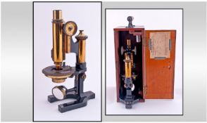 A Lacquered Brass and Black Enamelled Monocular Compound Microscope by W.Watson & Sons, London.