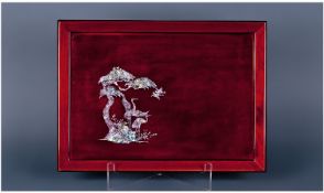 A Japanese Red Lacquer Tray Nicely Inlaid In Mother Of Pearl, with a view of cranes amongst trees.