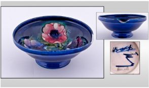 Moorcroft Footed Bowl ``Clematis`` Design. On blue ground. Signed to base. Diameter 6.25 inches.