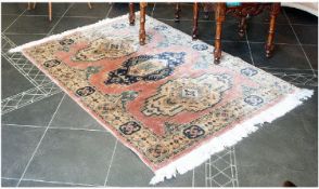 A Persian Style Prayer Rug, 120 by 170 cms on a pink ground with geometric design to the centre.