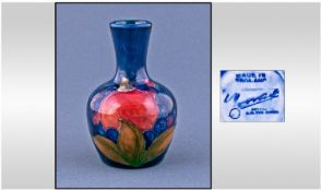 William Moorcroft Small Vase. Pomegranate and berries design. Stands 3.75 inches high.