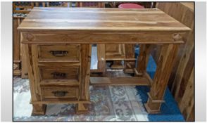 A Teak Knee Hole Type Side Cabinet, with a bank of three draws down one side, with an open appiture