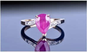 9ct Gold Ruby And Diamond Ring Set with a pear cut ruby between diamond shoulders. Fully