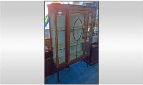 Edwardian Mahogany astral glazed cabinet with a central door. Flanked by 2 small glazed panels /