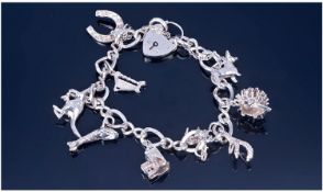 Silver Charm Bracelet Loaded With 9 Charms. Complete with safety chain and Padlock fastener.