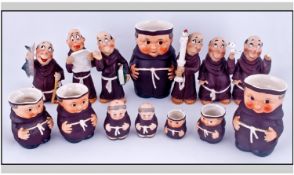 Set Of Six Graduating Jugs In The Form Of Monks. Together with 8 ceramic monk figures. Various