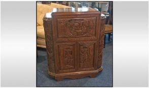 Carved teak wood Chinese cocktail cabinet. Fold down front with a mirrored interior. Side cabinets