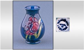 Moorcroft Salesman Sample Miniature Vase. Anemone design on blue ground. Height 2.25 inches.