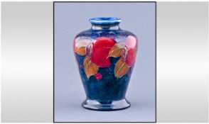 Moorcroft Small Vase. Pomegranate design on blue ground. Height 3.5 inches.
