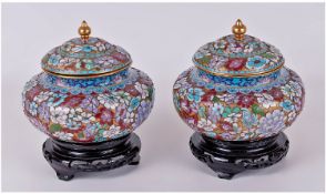 A Fine Pair Of Peking Cloisonne Lidded Bowls, with floral decoration and each raised on a carved
