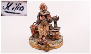 Capo Di Monte Signed Figure, titled `The Bookworm` of a gentleman down on his luck reading a book