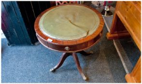 Reproduction Mahogany Drum Table with leather top. On Regency brass claw feet. 25 inches high and