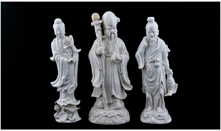 Three Blanc De Chine Chinese Figures depicting a Sage holding a peach, 11 inches in height, one is