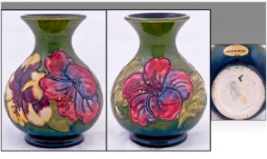 Moorcroft Vase `Hibiscus` Design on green ground. Moorcroft label to base. Height 5 inches. Mint