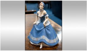 Royal Dux Figurine of a Lady in a blue dress, wearing a blue hat. Stamped to base ``Made in