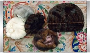 Collection of Mink comprising four mink hats and a hand muff.