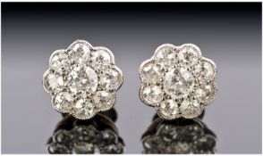 18ct Gold Set Pair Of Diamond Earrings, with flower head cluster design. Est 50 pts. Bright stones.