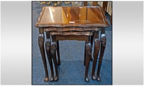 A Nest of Three Mahogany Coffee Tables of shaped form.