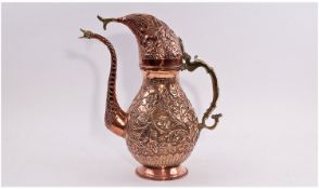 A Late 19th/20th Century Middle Eastern Copper Profusely Embossed Coffee Pot, with brass handle and