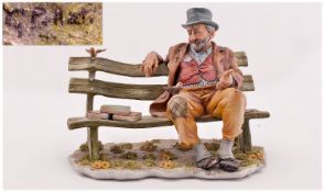 Capo Di Monte Fine And Early Signed Figure. Circa 1950`s. Tramp sitting on a bench with birds and