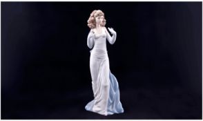 Lladro - Exclusive Figure ` Elegant Lady Holding a Flower ` Model No.6608. Stands 12.5 Inches Tall.