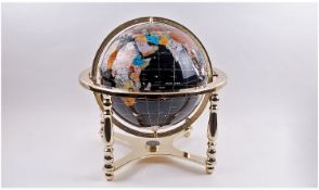 Brass Framed Coloured Globe. Surrounded and mounted on brass frame with a compass on the bottom.