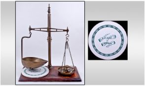 A Set Of Victorian Brass Toffee Scales, with a set of graduating weights on a mahogany base. Height