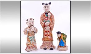 Two Late Nineteenth Century Decorated Satsuma Figures, one depicting a small boy with a mask in his