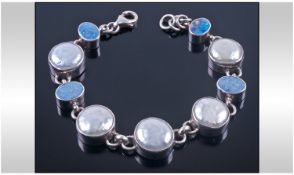 A Silver Bracelet set with pearl and opals. Marked 925 silver. 7 inches in length.