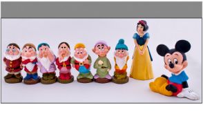 Disney Snow White and the Seven Dwarves Rubber Doll Set together with Mickey Mouse money box.