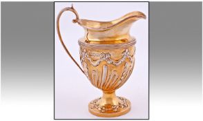 Edwardian Fine Silver Gilt And Embossed Helmet Shaped Jug in the Rococo Style. Hallmark London