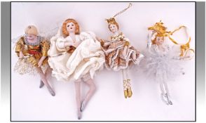 Four Bisque Headed Small Fairy Dolls/Figurines, with material dresses. Various sizes.