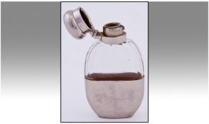A Small Quality Silver Plated And Glass Hip Flask. Height 4.5 inches.