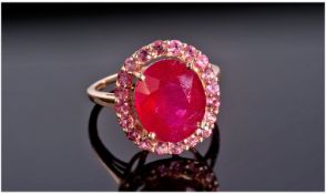 9ct Gold Ruby Ring Set With A Central Oval Cut Ruby Surrounded By Round Cut Rubies, Central Stone