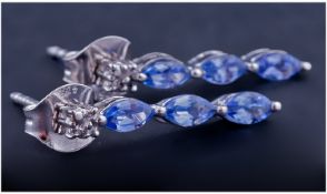 Tanzanite Trilogy Drop Earrings, with diamond accents, each earring having three marquise cut