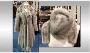 Ladies Full Length Grey Mink Coat. Scalloped edge to hem, fully lined, with tie belt. Slit pockets.