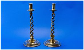 A Pair Of English Brass Barley Twist Candlesticks. Circa 1860s. Raised on circular stepped bases.