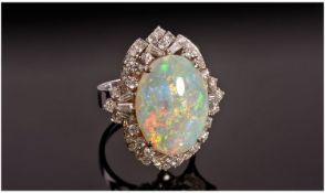 18ct White Gold Set Very Fine Opal and Diamond Cluster Ring. The oval shaped opal of good quality
