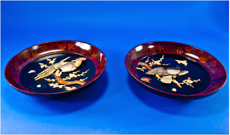 Pair of Japanese Lacquered Round Wall Plaques, raised and carved in mother of pearl and bone,