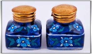 Pair of Gouda Porcelain Inkwells with brass hinged lids. 3 inches in height.