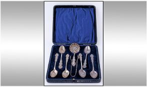 A Fine Silver Eight Piece Teaset comprises six ornate teaspoons, pair of sugar tongs, 1 carry