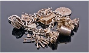 Silver Charm Bracelet Loaded With 11 Charms, Complete With Padlock And Chain Fastener.