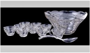 Glass Punch Bowl Set With 9 Glasses And Ladel. Etched floral and fruit design to all pieces.