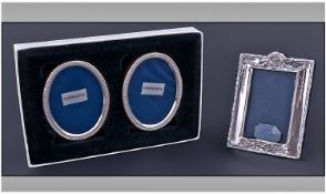 Three Silver Bedside Photo Frames. 1. A pair of oval beaded frames with solid easel backings and