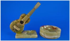 Green Onyx Novelty Guitar Ashtray, the carved acoustic guitar, supported on a brass pin, set at an