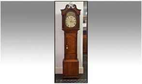Early 19th Century Grandfather Clock In An Oak Case, with mahogany cross bounding on bracket feet.